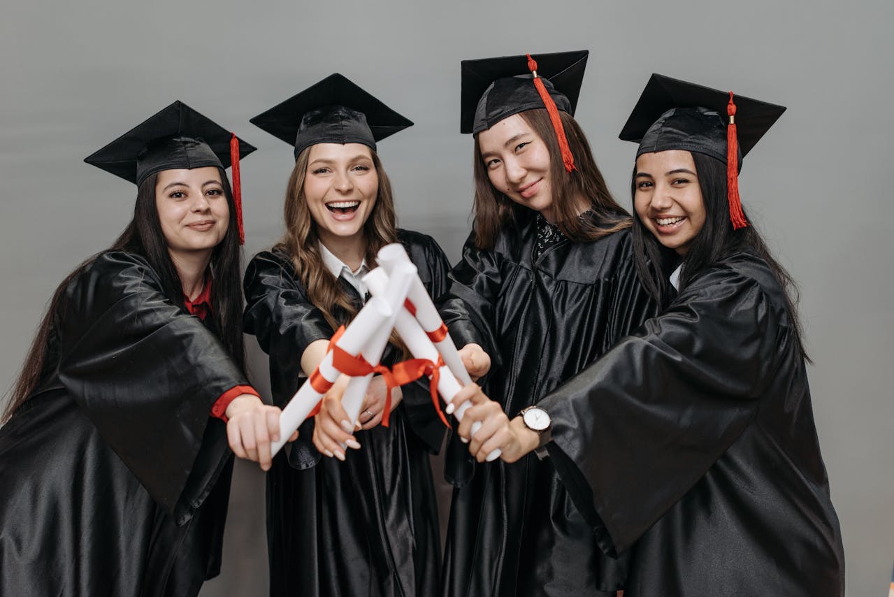 4 Students Holding Their Diploma